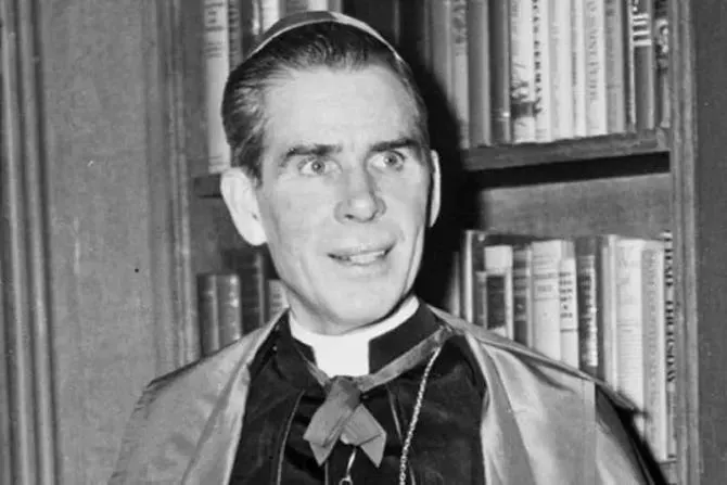 A high-ranking clergy member in the Catholic Church stands in front of a bookcase.